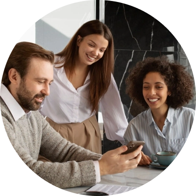 A diverse team of office colleagues collaborating over a laptop to manage personal team information